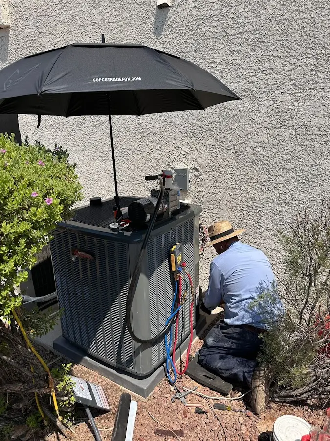 HVAC technician performing outdoor AC maintenance in Crandall